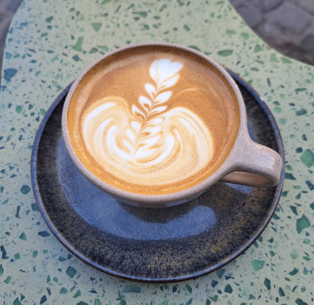 Coffee with latte art and pastries at Constantin café